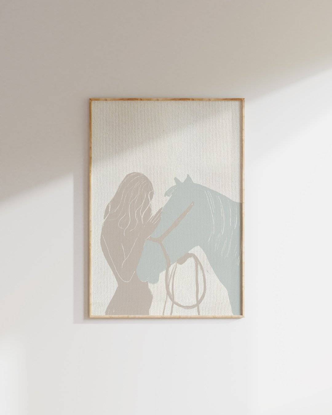 a picture of a woman and a horse hanging on a wall