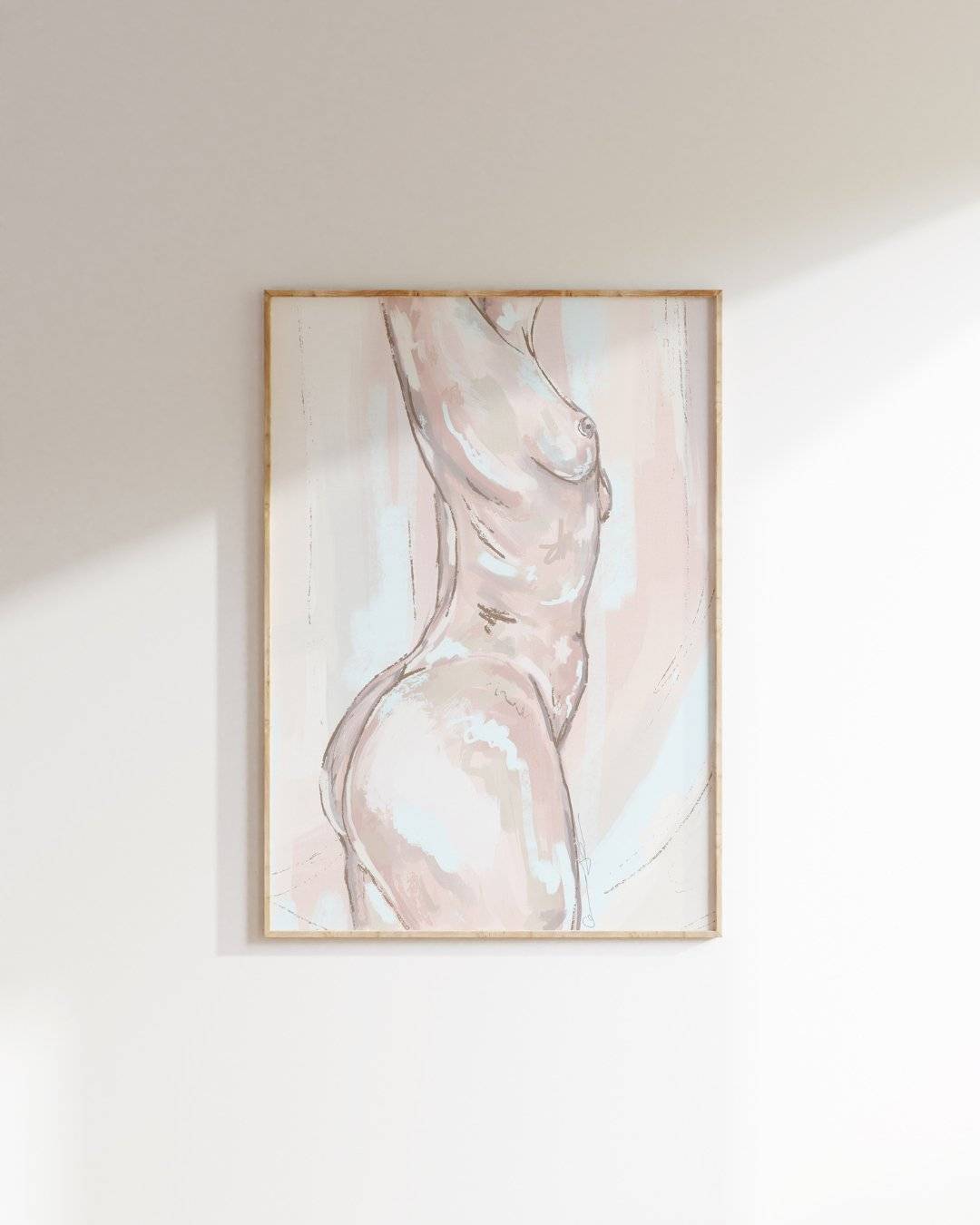 a picture of a nude woman hanging on a wall