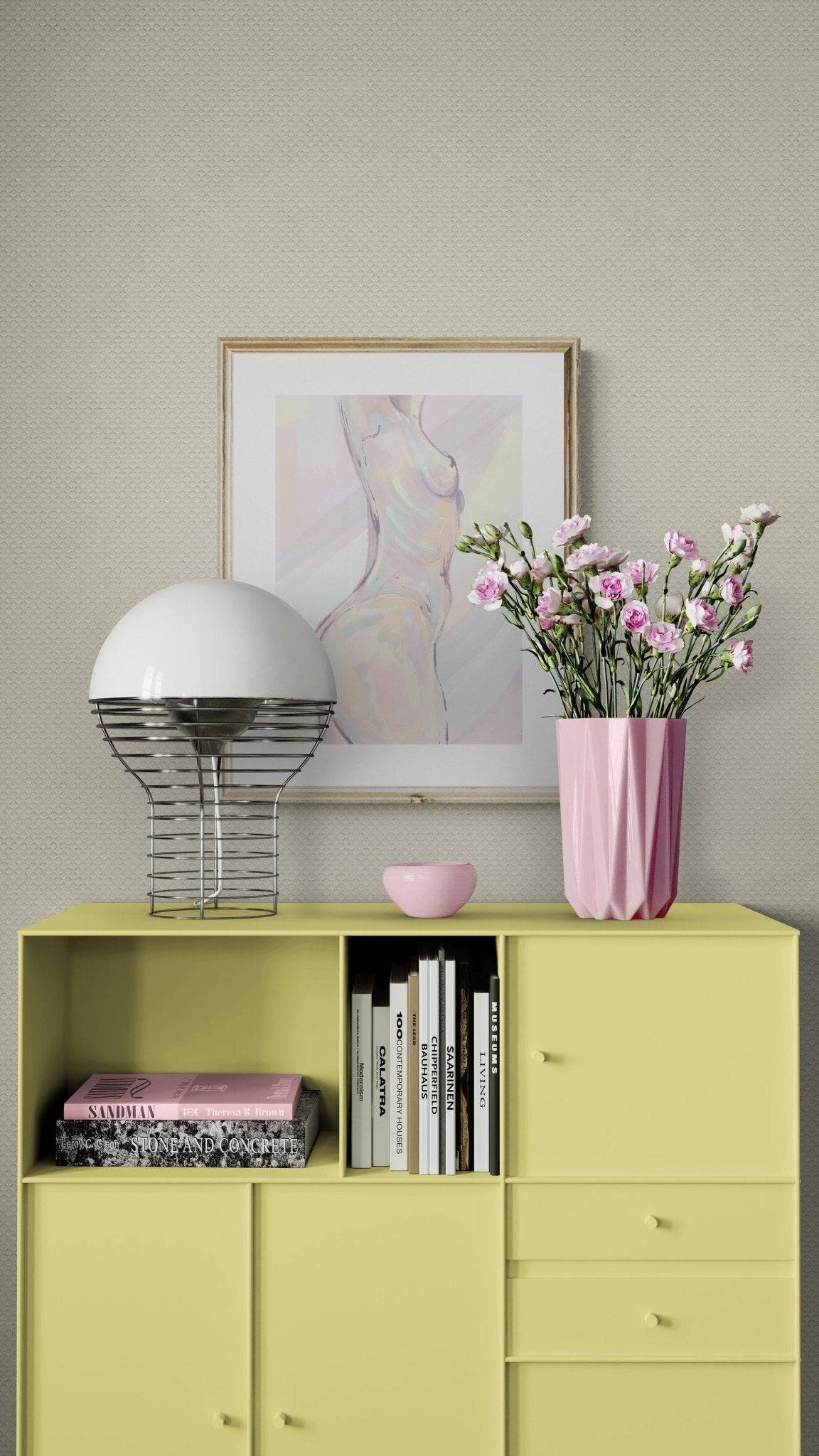a vase of flowers sitting on top of a yellow cabinet